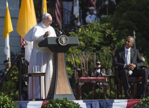 Pope Francis speaks alongside US President Barack Obama during an arrival ceremony on the South Lawn of the White House in Washington, DC, September 23, 2015. More than 15,000 people packed the South Lawn for a full ceremonial welcome on Pope Francis' historic maiden visit to the United States. AFP PHOTO / MANDEL NGAN        (Photo credit should read MANDEL NGAN/AFP/Getty Images)
